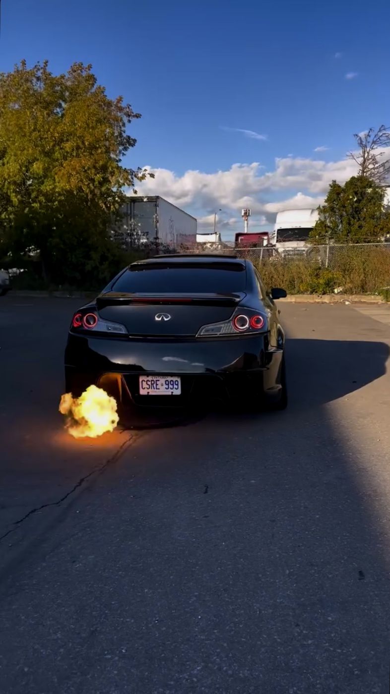 Infiniti shooting flames from the exhaust at sunset