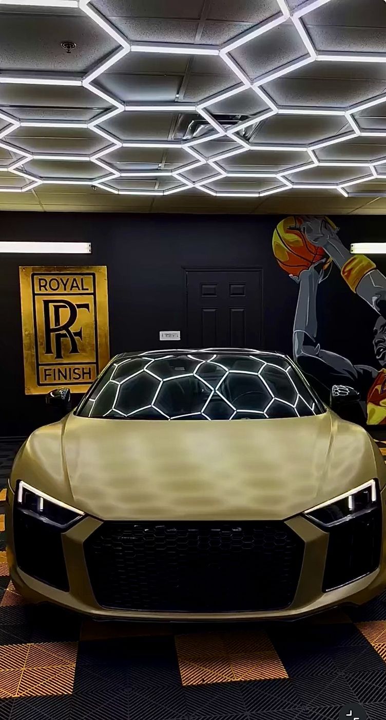 Audi R8 wrapped in gold under the hex lights